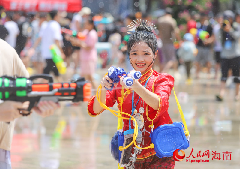 一名穿著少數(shù)民族服飾的女子，拿起裝備參與這場狂歡。人民網(wǎng)記者 牛良玉攝